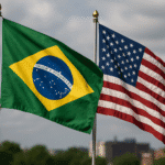 Bandeiras do Brasil e dos Estados Unidos lado a lado ao ar livre em céu parcialmente nublado. Disputa entre Brasil e EUA na OMC.